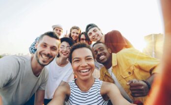 Group of diverse people smiling outdoors – representing positive community.